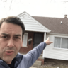 Clayton Morris points at a rental property